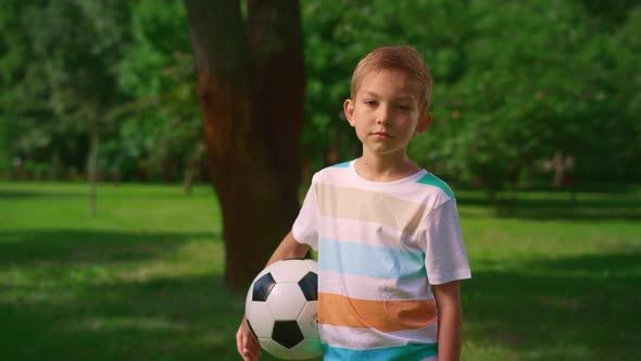 Boy with Soccer Ball Posing Camera on Nature alt