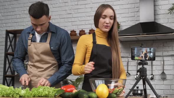 Food Blogging Young Woman Talking About Salad Preparing Process and Filming the Whole Process with a alt