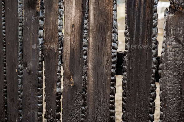 Burnt fence boards after a fire in a private house