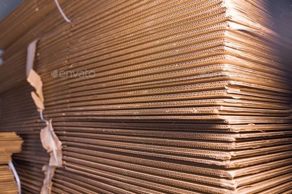 Close-up large cardboard piles lie on top Stock Photo by YouraPechkin