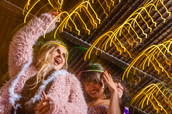 Young laadies having fun with their friends in a party - Stock Photo - Images