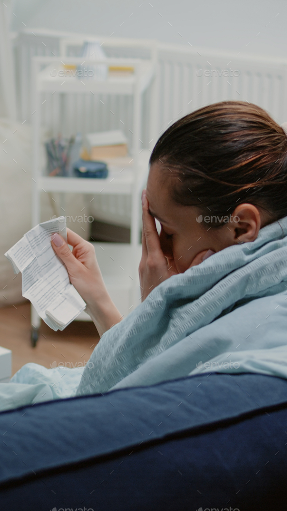 Ill woman reading package leaflet for information about medication