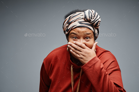 Senior Black Woman Covering Mouth
