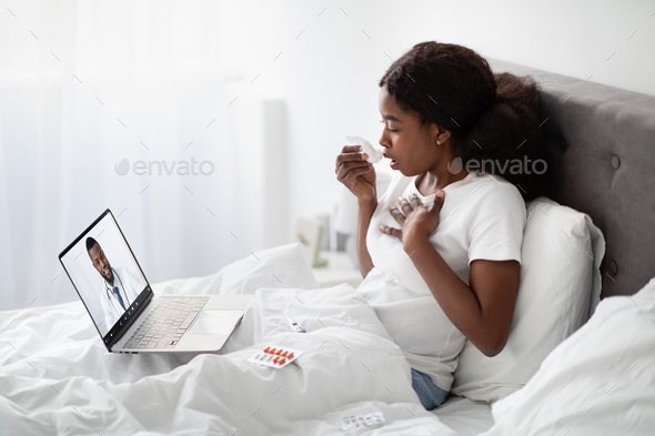 Sick black lady having video chat with physician