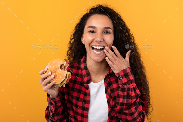 Happy Laughing Lady Eating Burger At Studio
