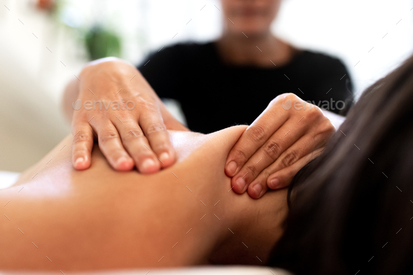 woman giving back massage to a girl Stock Photo