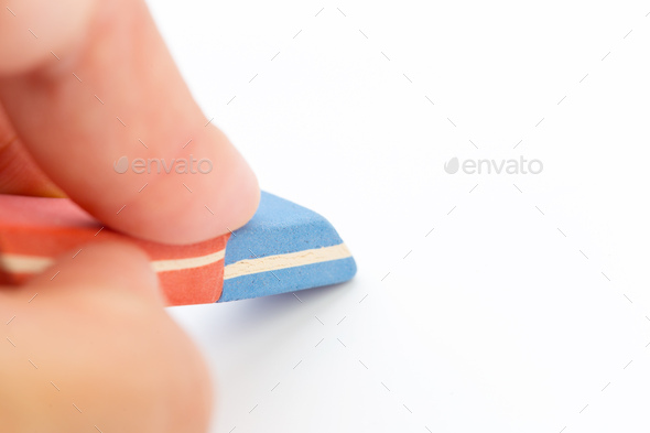 eraser tool in a hand isolated on white background. school and office tool