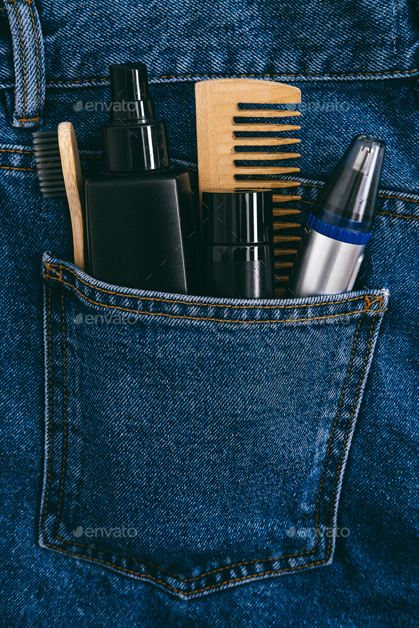 Men self care beauty kit, male beauty care cosmetic products and devices in blue jeans denim pocket