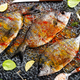 Raw fish with herbs, lemon and olive oil on dark textured background. - PhotoDune Item for Sale