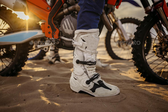 Motorcycle trials during motocross competition closeup rider boots