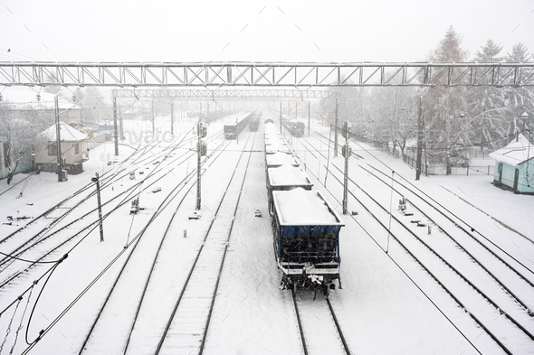 Train station with railways covered by snow in winter time