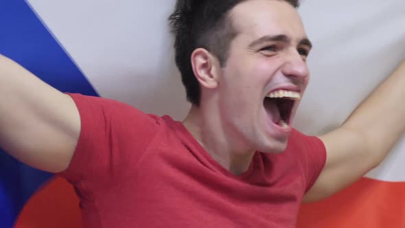 Czech Young Man Celebrating While Holding the Flag of Czech Republic in Slow Motion alt