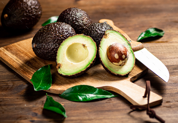 Halves of fresh avocado on a cutting board. 31996423 Stock Photo at Vecteezy