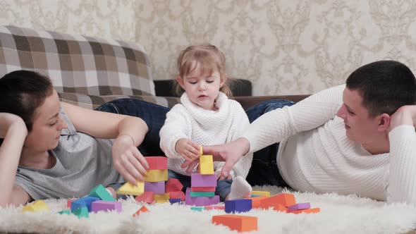 Dad Mother Kid Play Cubes in Nursery on Floor alt