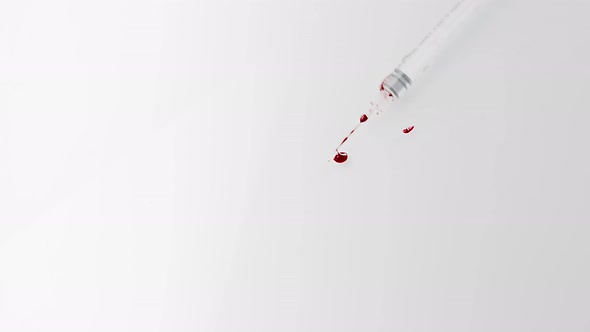 White Syringe with Blood Falls on the White Floor alt