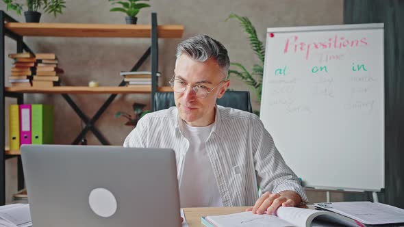 Middle Aged Male Teacher in Eyeglasses Video Chatting with Students Via Video Call in Internet alt