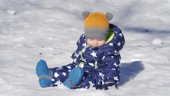 Baby Playing in the Snow in Winter 1 Year Old Baby Boy on a Walk in the Park alt