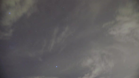 Night time sky timelapse, stars above clouds alt