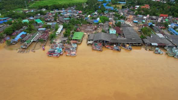 Aerial shot of river and local fisherman village beside the sea alt