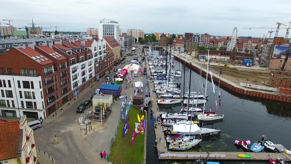 Moored yachts on the pier before the start of the sailing alt