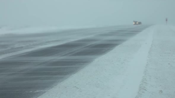 Cars on Winter Road at Blizzard alt