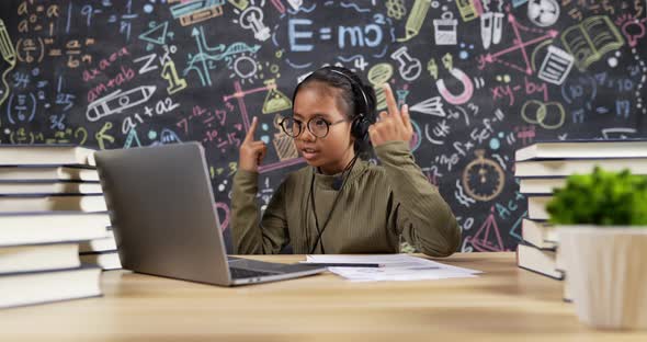 Girl kid studying and talking with headset alt