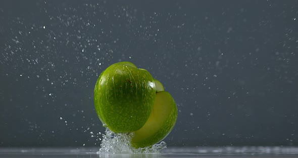 Granny Smith Apple, malus domestica, Fruit falling on Water against Black Background, Slow Motion 4K alt
