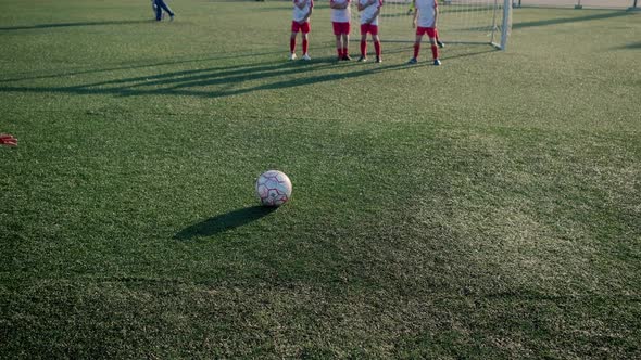 Boy Footballer Is Kicking Ball Into Goal Through Wall Of Players By Polly Belyaeva