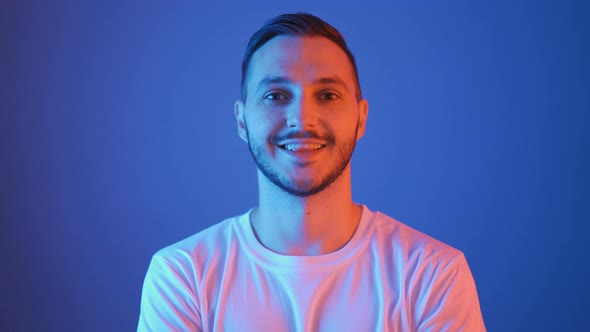 Portrait of Smiling Football Fan with Red and Blue Lights alt