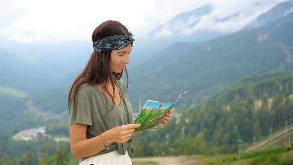 Happy Young Woman in Mountains in the Background of Fog alt