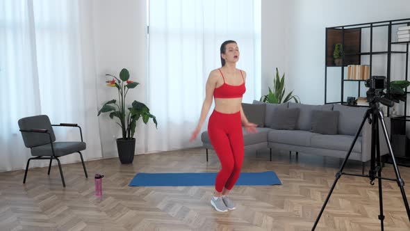 Fit Beautiful Woman Fitness Trainer Blogger Doing Exercise Jumps Workout Home alt