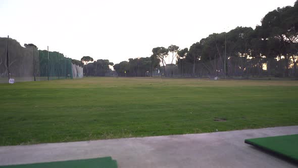 Practice area of ​​a golf course, the camera lowers slowly and changes the focus to an empty ball cu alt