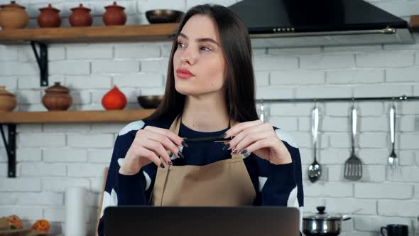 Thoughtful woman in apron thinks solution problem holiday restaurant food menu alt