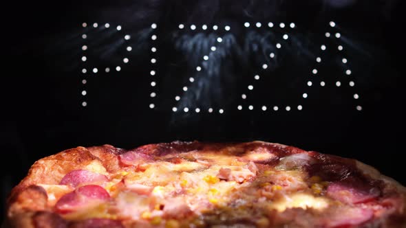 Delicious Fresh Italian Pizza On  A Black Background With The Effect Of Light Inscription Pizza