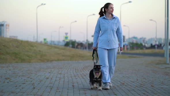 Young Woman in Blue Suit Walking Her Dog After Work