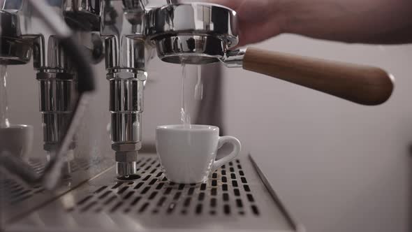 Low Angle Shot of Rinsing Water From Naked Portafilter alt