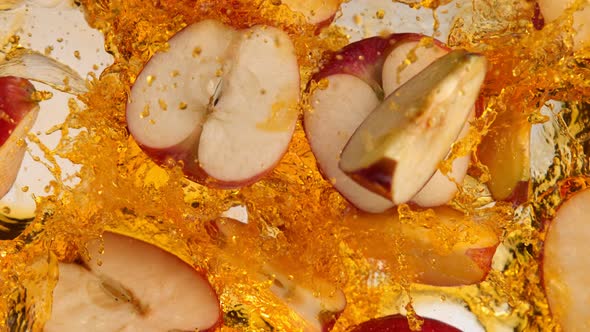 Super Slow Motion Shot of Red Apple Cuts Falling and Splashing Into Juice at 1000Fps alt