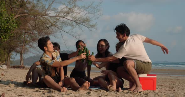Young man and woman party on the beach