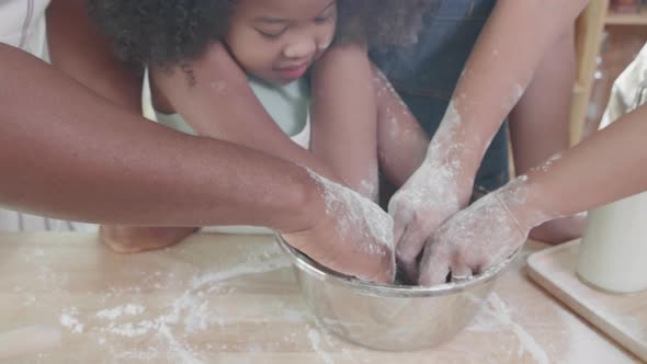 Close up of Happy African American family thresh dough together for cookie