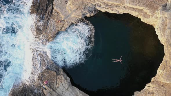 Above Aerial View of a Girl Floating and Swimming in Giola Sea Lagoon, Thassos, Greece alt