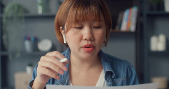 Asia businesswoman using tablet talk to colleagues about plan in video call while working.