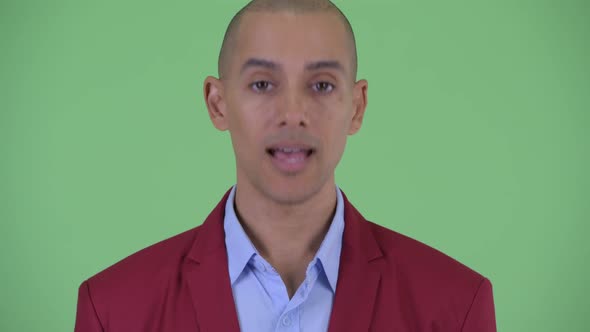 Face of Happy Bald Multi Ethnic Businessman Nodding Head Yes alt