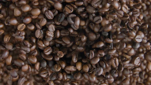 Coffee Beans Spilling Out Electric Grinder with Open Cover Close Up Top View alt