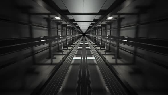 Inside the dark elevator shaft. Vertical construction witch machinery and ropes. alt