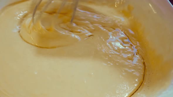 The Process of Preparing Liquid Dough for Pancakes Stirring the Mixture with a Whisk for Further