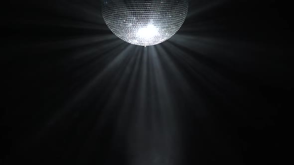 Silver Mirror Disco Ball Rotating in Black Space alt
