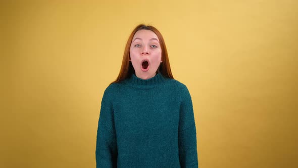 Young Red Hair Woman in Green Sweater Posing Isolated on Yellow Color Background Studio