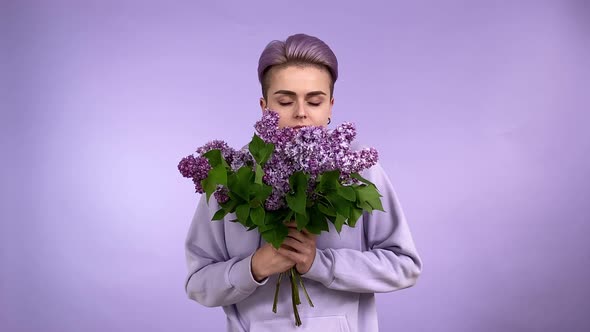 Young Woman Gen Z Smelling Lilac Bouquet Purple Monochrome Concept alt