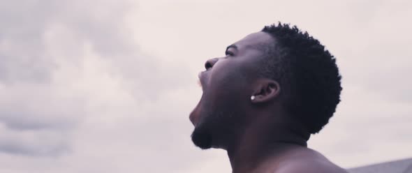 Motivated black man on rooftop alt