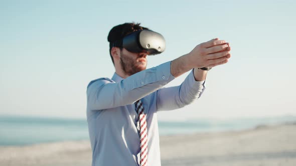 Business Man Practicing Relaxation with Virtual Reality Headset at the Beach alt